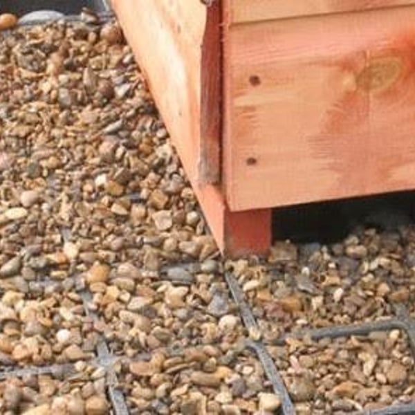 Fastfit grid shed base filled with pea gravel on a level garden site